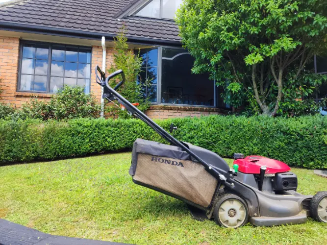 Honda lawn mower in front of house